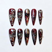 Crimson Widow burgundy gothic stiletto press-on nails with spiders, webs and ornate charms, full 10-piece set