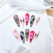 Fuchsia Lace pink and black gothic stiletto press-on nails styled with white feathers