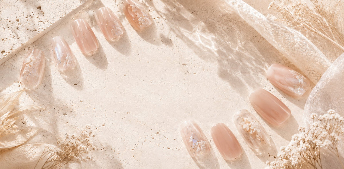 Neutral SHEZAIR press-on nails photographed on stone in natural light